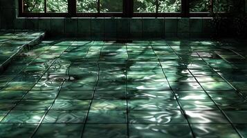 Serene indoor space with green tiled floor reflecting light and water, surrounded by lush greenery photo