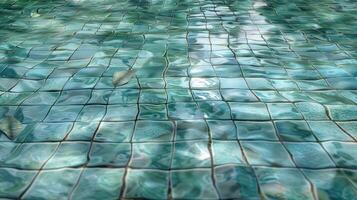 Tranquil turquoise tiled pool surface reflecting sunlight with gentle water ripples photo