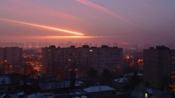 Serene sunset over a cityscape with illuminated buildings and a tranquil atmosphere photo