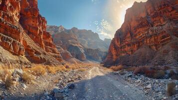 Vibrant canyon landscape with rocky terrain, sunlight casting shadows, and serene atmosphere photo