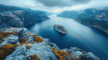 Scenic view of a tranquil fjord surrounded by mountains and autumn foliage under cloudy skies photo