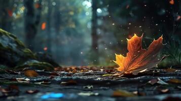 A vibrant autumn leaf rests on a forest floor, surrounded by fallen leaves and soft light filtering through trees photo