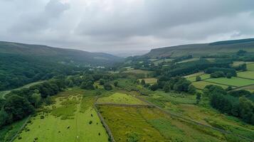 Aerial view of a lush green valley surrounded by rolling hills and cloudy skies photo