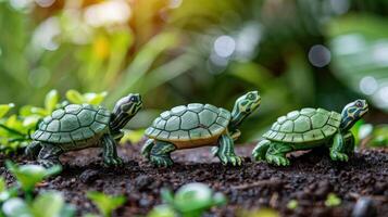 Three colorful turtle figurines lined up on soil amidst lush green foliage, capturing a serene moment photo