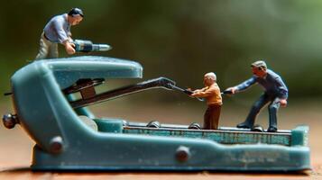 Miniature figures using a vintage stapler as a construction site in a blurred natural background photo