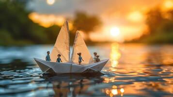 Miniature paper boat sailing on a tranquil river at sunset with tiny figures enjoying the view photo