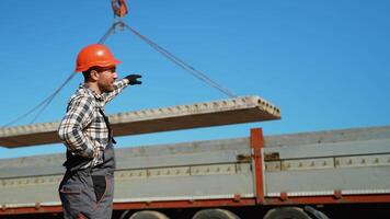 Worker Directing Unloading of Concrete Slab from Truck video