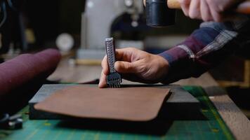 Leatherworker Using Stitching Punch Tool and Mallet video