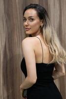 Elegant Blonde in a Black Dress Exuding Confidence and Timeless Beauty. photo