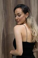 Elegant Blonde in a Black Dress Exuding Confidence and Timeless Beauty. photo