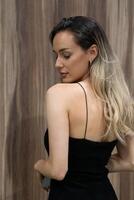 Elegant Blonde in a Black Dress Exuding Confidence and Timeless Beauty. photo