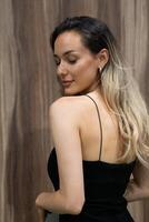 Elegant Blonde in a Black Dress Exuding Confidence and Timeless Beauty. photo