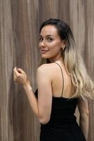 Elegant Blonde in a Black Dress Exuding Confidence and Timeless Beauty. photo