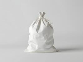 White bag with a drawstring on a plain surface photo