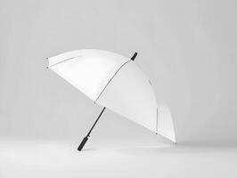 A white umbrella with black handle on a white surface photo