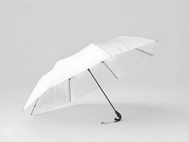 A white umbrella with a black handle on a gray background photo