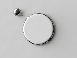 A white button and a round object on a gray background photo