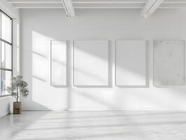 Empty white room with three blank frames on the wall photo