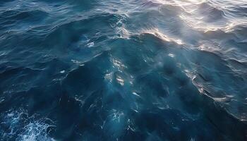 The ocean is seen from above with waves and sun photo