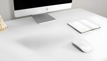 A white desk with a computer, mouse, and books photo