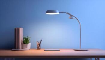 A desk lamp is on a table next to a book and a plant photo