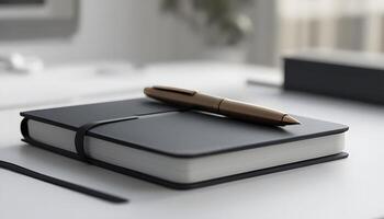 A pen and notebook on a desk with a window photo