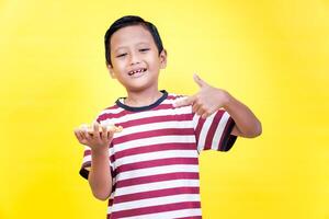 a boy holding a piece of pizza in his hand photo