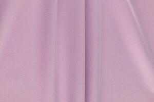 Beautiful delicate texture of dense fabric in a pink, lilac shade. a few soft folds of fabric. fabric background for design. layout. A copy space. photo