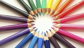 A creative arrangement of colored pencils forming a perfect circular pattern, with their sharpened tips facing inward photo
