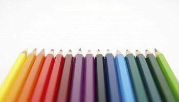 A set of colored pencils arranged in a perfect gradient from light to dark photo