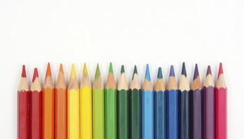 A row of sharpened colored pencils neatly aligned in a straight line, with their tips facing upwards. create rainbow color gradation, forming a beautiful gradient photo