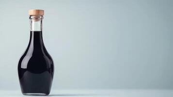 Bottle of balsamic vinegar on grey photo