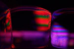 Red and purple reflections of the liquid in macro, flat liquid surface photo