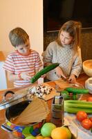 They work as a team, sharing tasks and helping each other with the cutting. photo