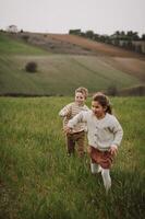 The children run across the open field, their laughter blending with the warm afternoon breeze. photo
