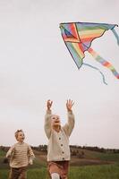 The kite flutters in the breeze, leading the children on a playful chase through the fields. photo