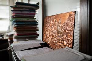 A workspace overwhelmed with piles of files and folders, symbolizing a demanding and fast-paced job. photo