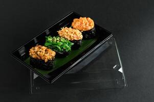 A beautifully presented sushi and sashimi platter features tender cuts of salmon, tuna, and eel, served with wasabi and pickled ginger. photo