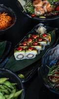 Fresh sashimi, sushi rolls, and delicate nigiri are artfully displayed on a dark table, accompanied by wasabi, soy sauce, and pickled ginger. photo