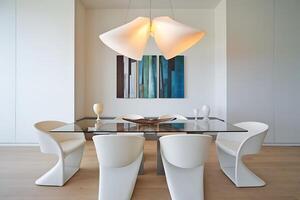 A dining room table with chairs and a glass top photo