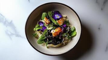A bowl of pasta with greens and flowers photo