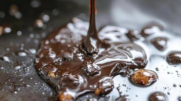 A close up of chocolate being poured into a pan photo