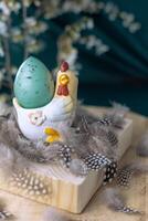 Easter chicken stand with egg on a wooden background with feathers. photo