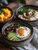 Healthy breakfast bowl with avocado, egg, and mushroom on quinoa photo