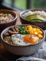 Vibrant breakfast bowl with quinoa, egg, avocado, and mango photo