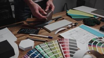 Unrecognizable interior designers select materials and color schemes for a modern apartment project. Teamwork in an architectural studio. video
