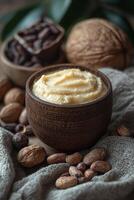 Cozy arrangement of shea butter cream with raw shea nuts and cocoa beans. photo
