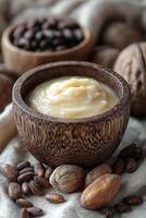 Cozy arrangement of shea butter cream with raw shea nuts and cocoa beans. photo