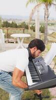 Musician Arranges His Keyboard For The Evening Performance In A Park video