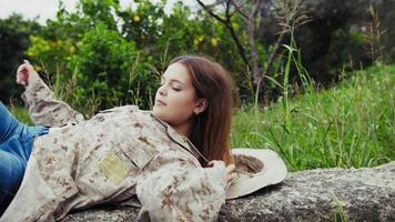 Girl With Camouflage Uniform Wakes Up In The Middle Of Nature Among Trees video